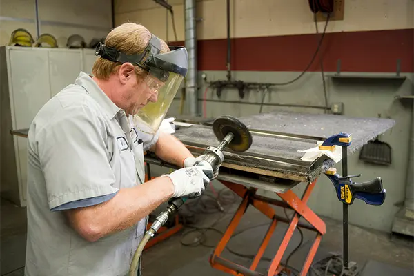 Worker using a buffing tool