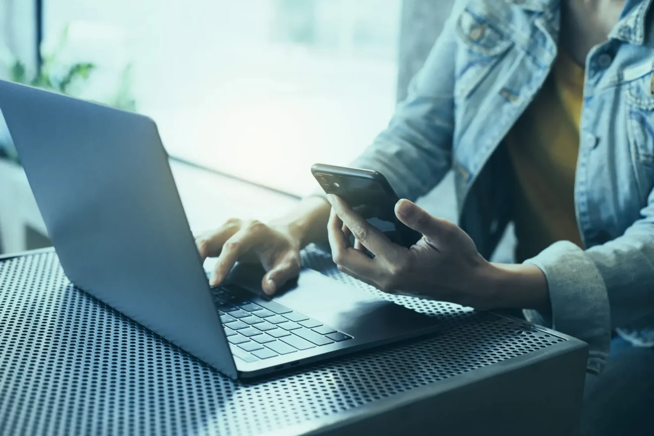 Woman working on her laptop and mobile phone