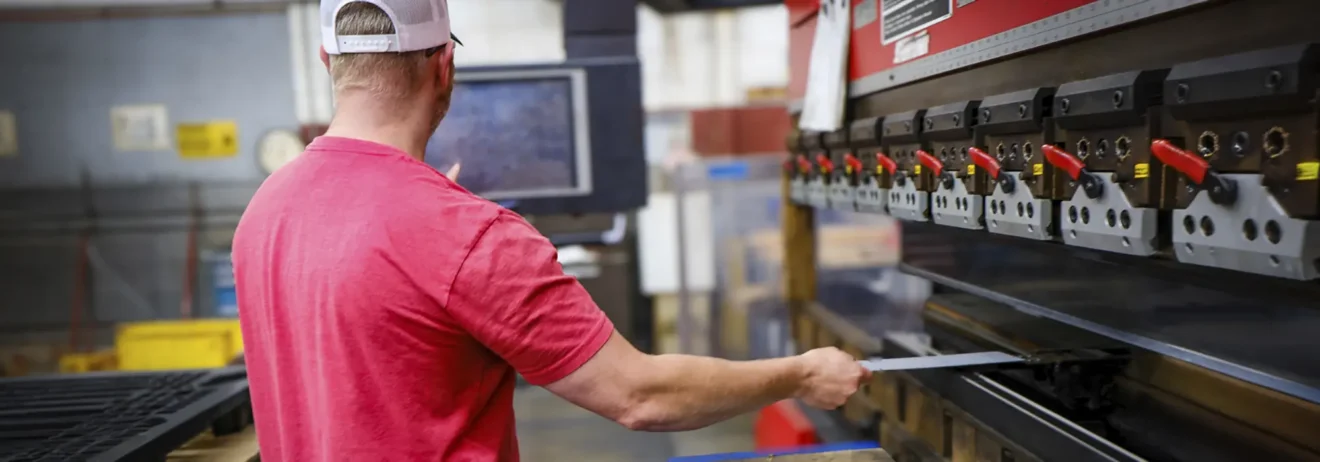 Worker running a metal fabrication machine